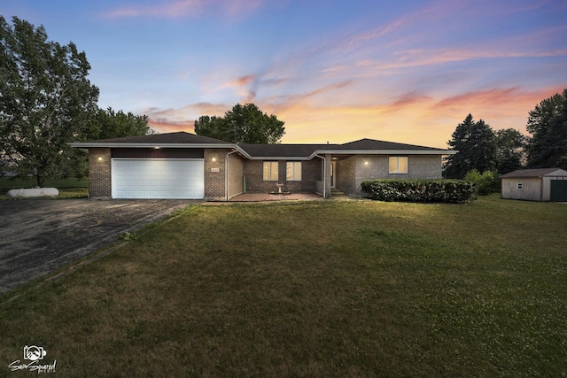 4849 W Kennedy Rd, Peotone, IL 60468 - single story home with driveway, a garage, a storage unit, brick siding, and a lawn