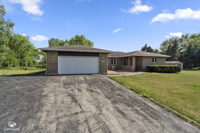 4849 W Kennedy Rd, Peotone, IL 60468 - ranch-style house with brick siding, a front yard, asphalt driveway, and a garage