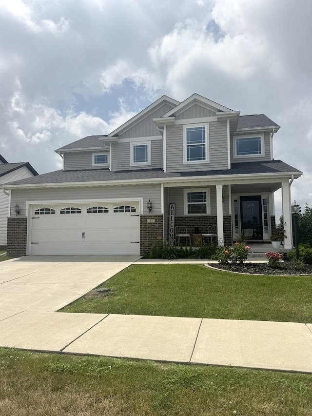 23 Lodge Trl, Monticello, IL 61856 - craftsman-style home with driveway, a porch, a front yard, brick siding, and board and batten siding