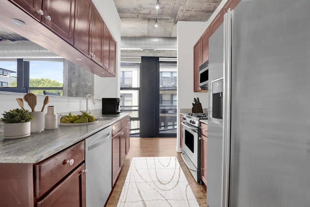 1070 W 15th St Unit 201, Chicago, IL 60608 - kitchen with stainless steel appliances, light wood finished floors, track lighting, and light countertops
