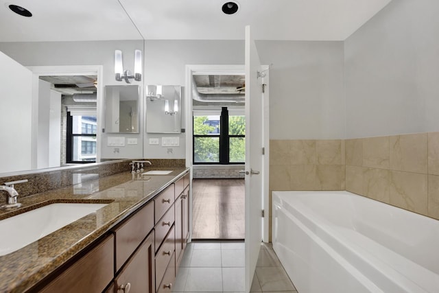 1070 W 15th St Unit 201, Chicago, IL 60608 - bathroom with double vanity, a bath, and tile patterned floors