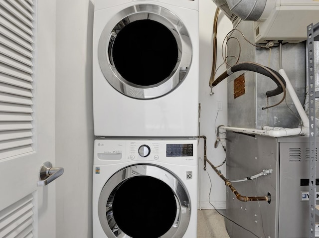 1070 W 15th St Unit 201, Chicago, IL 60608 - laundry area featuring stacked washer and clothes dryer and heating unit