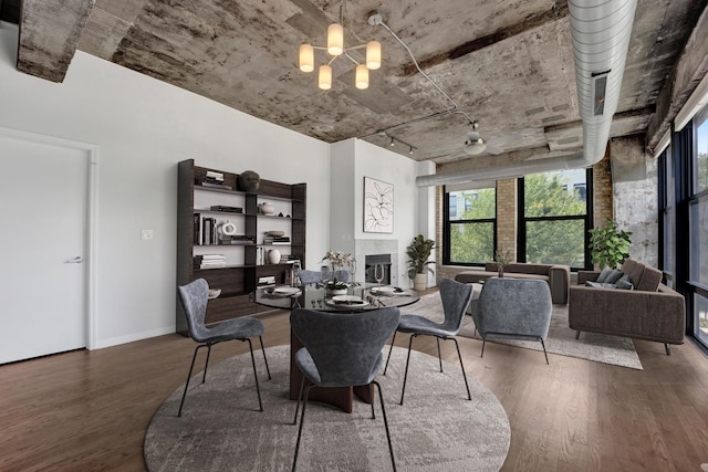 1070 W 15th St Unit 201, Chicago, IL 60608 - dining space featuring wood finished floors, a fireplace, and a chandelier