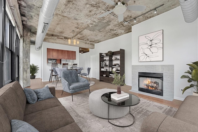 1070 W 15th St Unit 201, Chicago, IL 60608 - living room with track lighting, ceiling fan, light wood-type flooring, and a tile fireplace