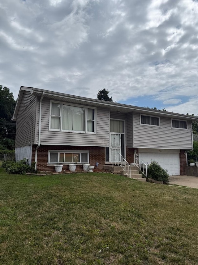 15203 Waterman Dr, South Holland, IL 60473 - raised ranch featuring a garage, brick siding, a front yard, and driveway