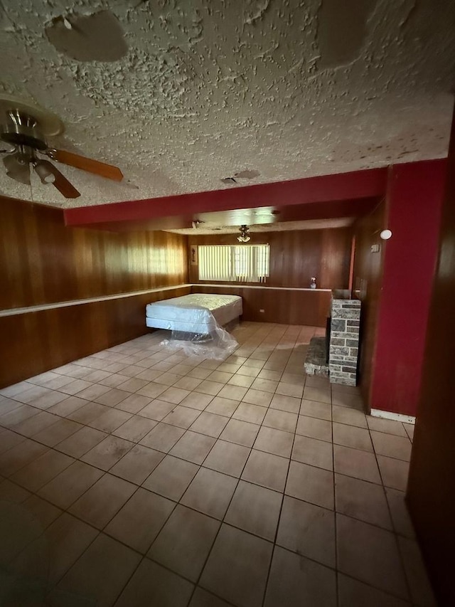 15203 Waterman Dr, South Holland, IL 60473 - unfurnished bedroom with a textured ceiling, tile patterned flooring, wood walls, and billiards