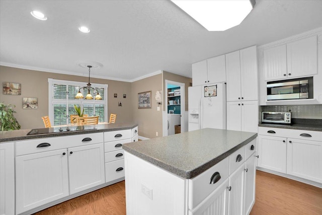 19615 116th Ave, Mokena, IL 60448 - kitchen featuring white fridge with ice dispenser, stainless steel microwave, black electric stovetop, dark countertops, and light wood-type flooring