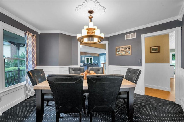 19615 116th Ave, Mokena, IL 60448 - dining room featuring a chandelier, carpet floors, crown molding, and wainscoting