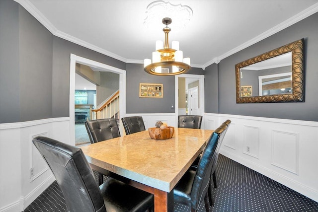 19615 116th Ave, Mokena, IL 60448 - dining room featuring ornamental molding, a chandelier, wainscoting, and dark colored carpet