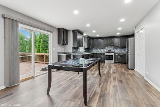 1110 Natalie Dr, West Chicago, IL 60185 - kitchen with backsplash, appliances with stainless steel finishes, wood finished floors, recessed lighting, and light countertops