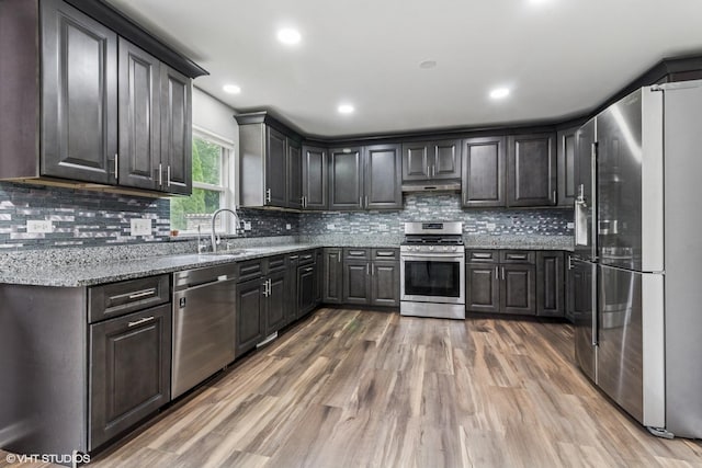 1110 Natalie Dr, West Chicago, IL 60185 - kitchen with appliances with stainless steel finishes, light wood finished floors, light stone counters, backsplash, and recessed lighting