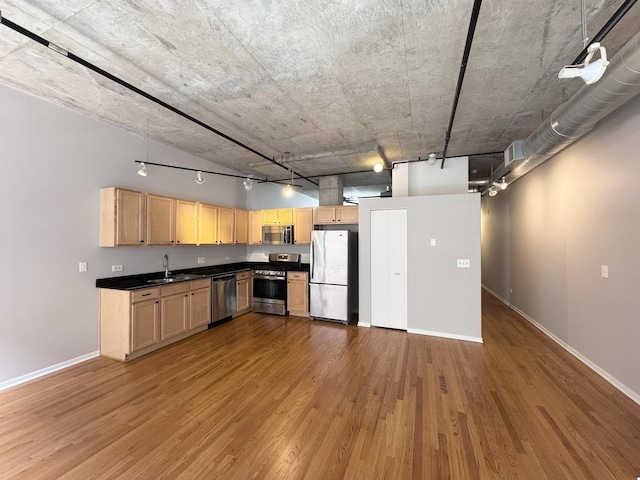 933 W Van Buren St Unit 424, Chicago, IL 60607 - kitchen with appliances with stainless steel finishes, wood finished floors, light brown cabinetry, and dark countertops