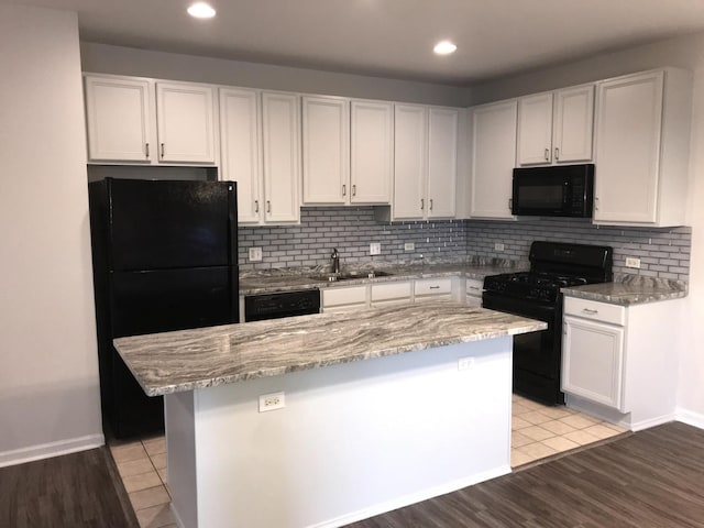 948 W 15th Pl Unit 1B, Chicago, IL 60608 - kitchen with black appliances, light stone counters, white cabinets, and recessed lighting