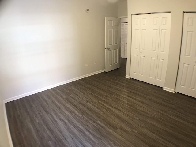 948 W 15th Pl Unit 1B, Chicago, IL 60608 - unfurnished bedroom with dark wood-type flooring and multiple closets