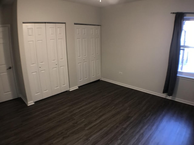 948 W 15th Pl Unit 1B, Chicago, IL 60608 - unfurnished bedroom featuring two closets and dark wood-style floors
