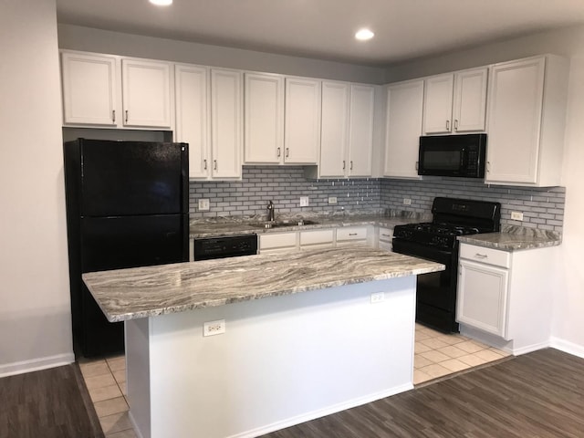 948 W 15th Pl Unit 1B, Chicago, IL 60608 - kitchen featuring black appliances, white cabinetry, light stone countertops, recessed lighting, and tasteful backsplash