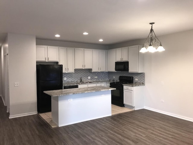 948 W 15th Pl Unit 1B, Chicago, IL 60608 - kitchen with black appliances, light wood-style floors, backsplash, a center island, and decorative light fixtures