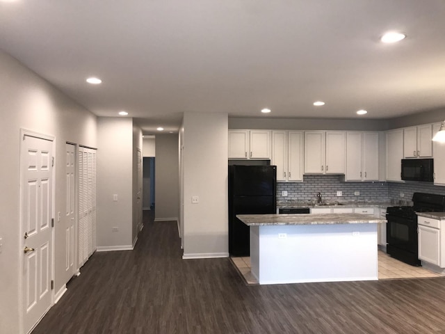 948 W 15th Pl Unit 1B, Chicago, IL 60608 - kitchen with black appliances, wood finished floors, a center island, white cabinetry, and recessed lighting