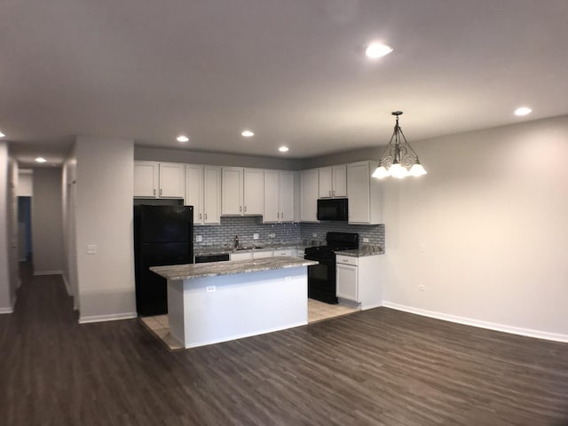 948 W 15th Pl Unit 1B, Chicago, IL 60608 - kitchen with black appliances, a center island, wood finished floors, tasteful backsplash, and recessed lighting