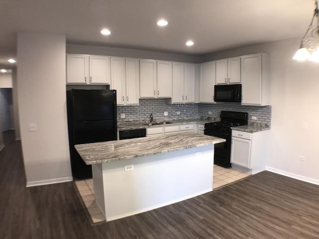948 W 15th Pl Unit 1B, Chicago, IL 60608 - kitchen with black appliances, tasteful backsplash, a kitchen island, light wood-style flooring, and recessed lighting