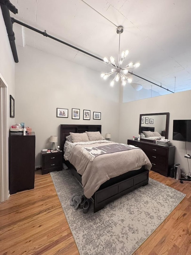 1224 W Van Buren St Unit 506, Chicago, IL 60607 - bedroom with light wood-style floors and a chandelier