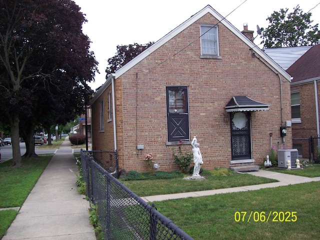 view of front of property with a chimney and brick siding