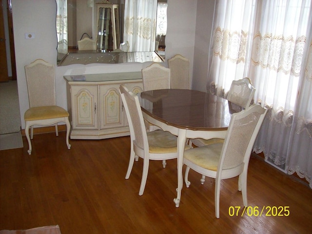 dining area featuring plenty of natural light and wood finished floors