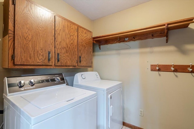 201 N Broadway St, Hudson, IL 61748 - laundry area featuring cabinet space, washer and dryer, and a textured ceiling