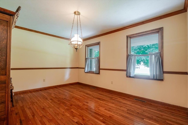 201 N Broadway St, Hudson, IL 61748 - empty room featuring wood finished floors and crown molding