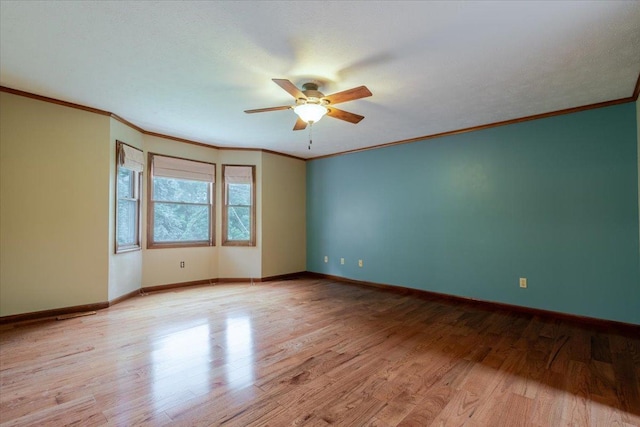 201 N Broadway St, Hudson, IL 61748 - unfurnished room with a ceiling fan, light wood-style floors, and crown molding