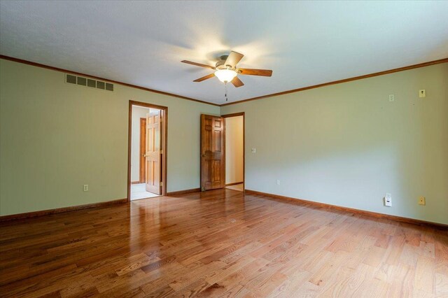 201 N Broadway St, Hudson, IL 61748 - spare room with a ceiling fan, wood finished floors, and crown molding