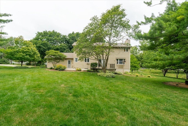 201 N Broadway St, Hudson, IL 61748 - back of property with a chimney and a yard