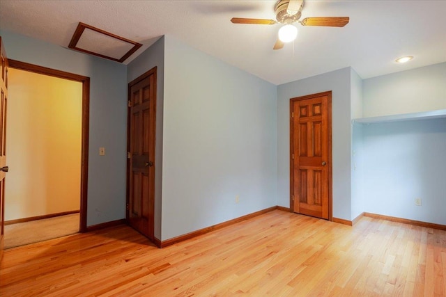 201 N Broadway St, Hudson, IL 61748 - empty room featuring light wood-style floors, attic access, and ceiling fan