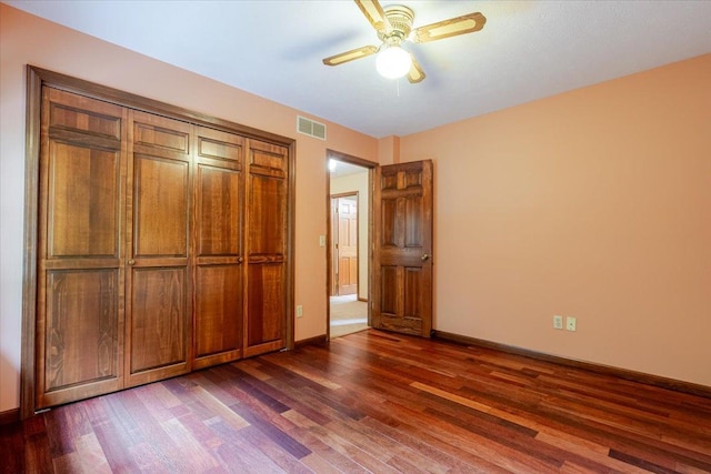 201 N Broadway St, Hudson, IL 61748 - unfurnished bedroom featuring dark wood finished floors and a ceiling fan