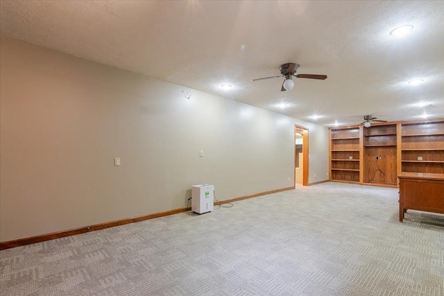 201 N Broadway St, Hudson, IL 61748 - finished below grade area featuring light carpet, ceiling fan, a textured ceiling, built in features, and recessed lighting