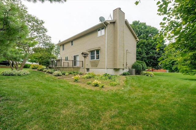 201 N Broadway St, Hudson, IL 61748 - back of house with a yard, a deck, and a chimney