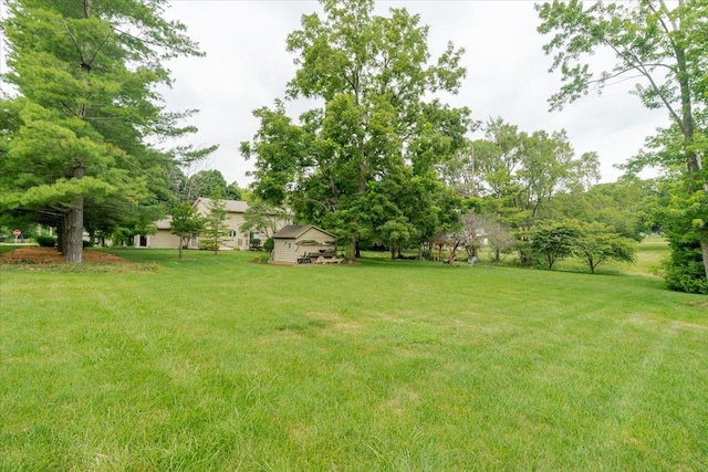 201 N Broadway St, Hudson, IL 61748 - view of grassy yard with an outbuilding