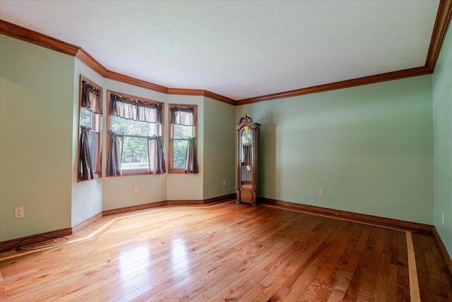 201 N Broadway St, Hudson, IL 61748 - spare room featuring light wood-style floors and ornamental molding