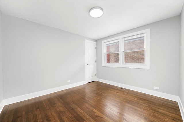 819 E 98th Pl, Chicago, IL 60628 - spare room featuring baseboards and dark wood-style floors