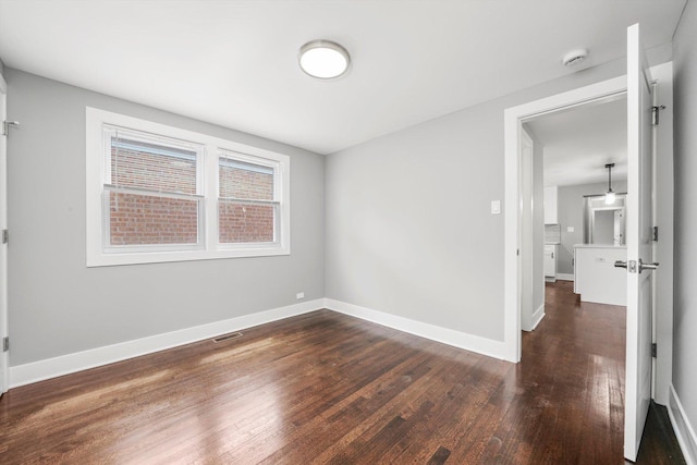 819 E 98th Pl, Chicago, IL 60628 - unfurnished room with wood finished floors and baseboards
