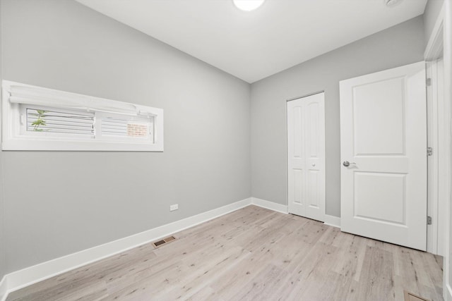 819 E 98th Pl, Chicago, IL 60628 - unfurnished bedroom featuring light wood-style floors and a closet
