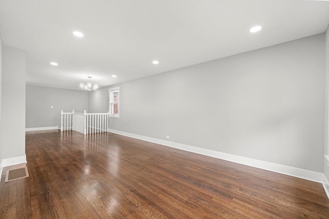 819 E 98th Pl, Chicago, IL 60628 - unfurnished room with a chandelier, recessed lighting, and dark wood-type flooring
