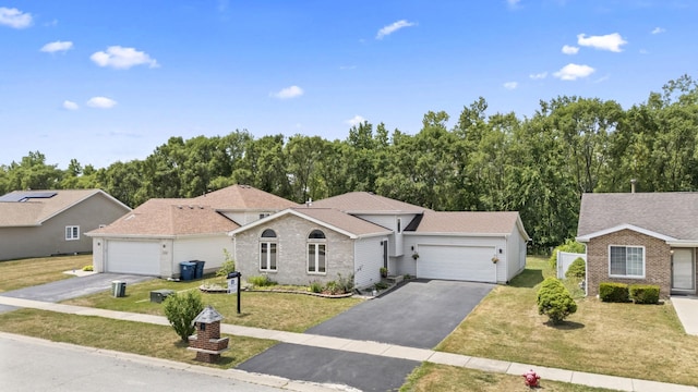 22514 Plum Creek Dr, Sauk Village, IL 60411 - ranch-style house with an attached garage, driveway, a front yard, and brick siding