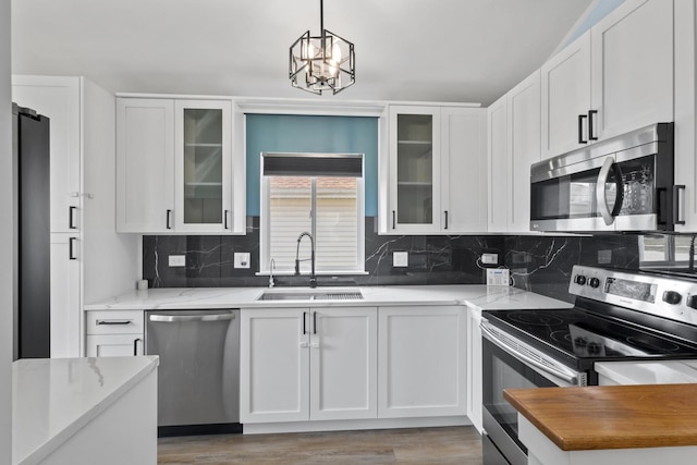 22514 Plum Creek Dr, Sauk Village, IL 60411 - kitchen with appliances with stainless steel finishes, white cabinetry, and light stone countertops