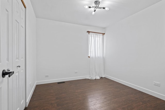 22514 Plum Creek Dr, Sauk Village, IL 60411 - unfurnished bedroom with dark wood-style flooring, a closet, and a chandelier