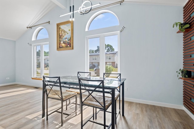 22514 Plum Creek Dr, Sauk Village, IL 60411 - dining area featuring wood finished floors, beam ceiling, a chandelier, and high vaulted ceiling