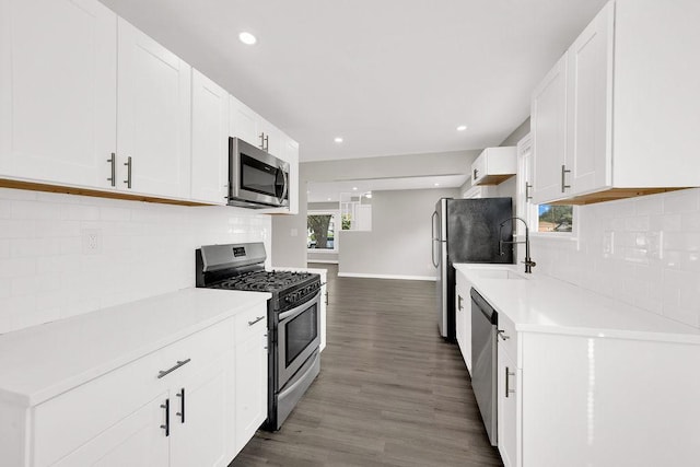 17841 Lorenz Ave, Lansing, IL 60438 - kitchen featuring appliances with stainless steel finishes, wood finished floors, light countertops, decorative backsplash, and recessed lighting