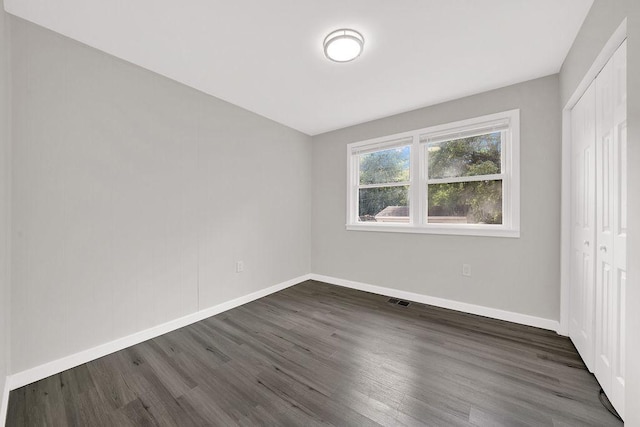 17841 Lorenz Ave, Lansing, IL 60438 - unfurnished bedroom with dark wood-style floors and a closet