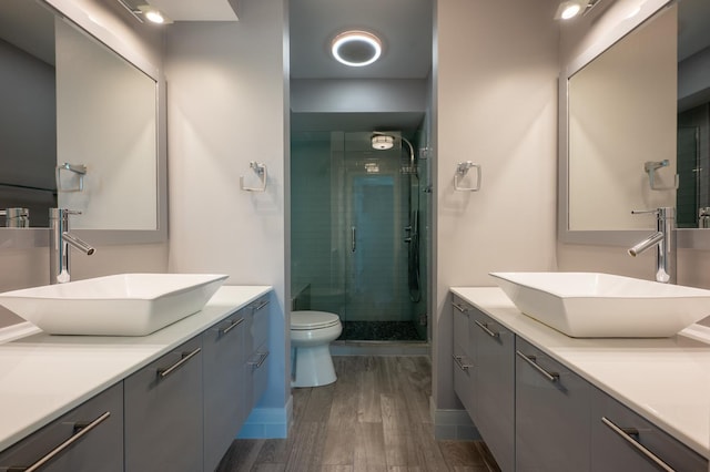 937 W Wrightwood Ave Unit C, Chicago, IL 60614 - bathroom with a stall shower, wood finished floors, and vanity