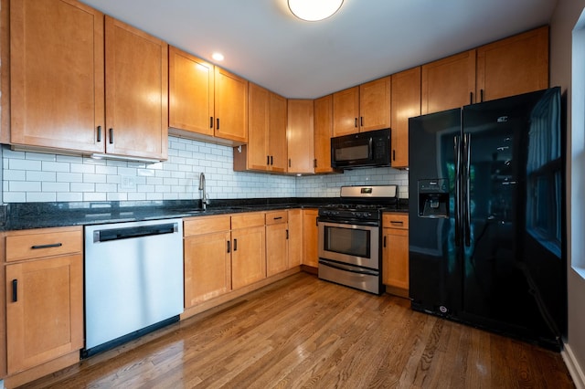 937 W Wrightwood Ave Unit C, Chicago, IL 60614 - kitchen featuring black appliances, wood finished floors, and decorative backsplash